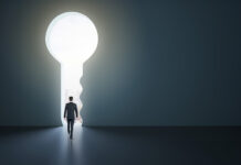 How Boards Unlock Growth in a Volatile Economy Back view of businessman standing in abstract key opening in wall with bright light and mock up place. Solution and decision concept