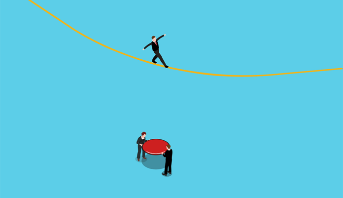 An illustration of a businessman walking a tightrope with two others holding a safety net beneath