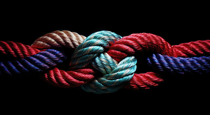 Different colored ropes knotted together over a dark background, signifying cohesion and trust