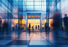 Execs at Middle-Market Companies: Why They Stay or Why They Go Blurred people entering a modern glass building
