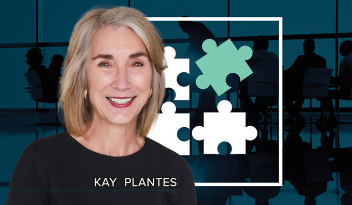 Kay Plantes headshot - a white woman with blonde shoulder-length hair and a black crew neck sweater - overlaid on a dark blue background depicting a board meeting with a graphic of four puzzle pieces in a white box at the center