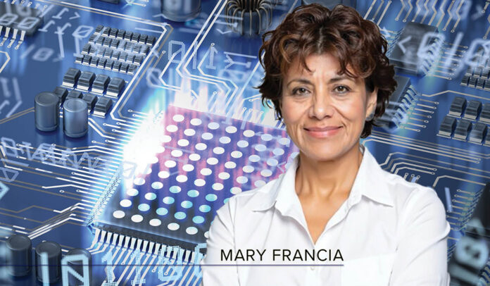 Headshot of Mary Francia - white woman with short wavy brown hair wearing a white button-down shirt - overlaid on a background depicting a quantum computing concept in tones of purple, blue and gray. Circuit and qubits in background.